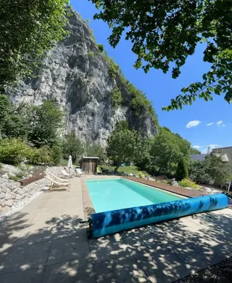 a swimming pool in front of a mountain at Holiday Home Katričnek in Bohinjska Bela