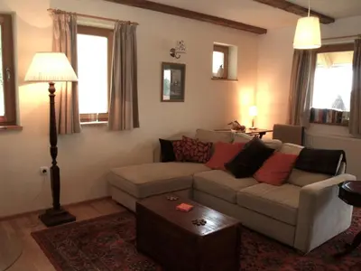 a living room with a couch and a table at Holiday Home Katričnek in Bohinjska Bela