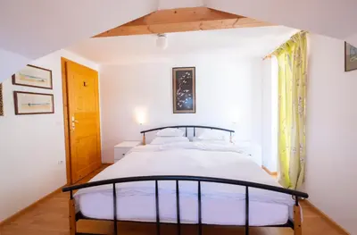 a bedroom with a large bed in a room at Holiday Home Katričnek in Bohinjska Bela