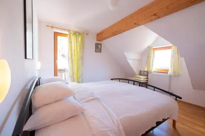 a bedroom with a bed in a attic at Holiday Home Katričnek in Bohinjska Bela