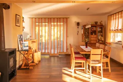 a kitchen and dining room with a table and chairs at Holiday Home Razglednik in Logatec