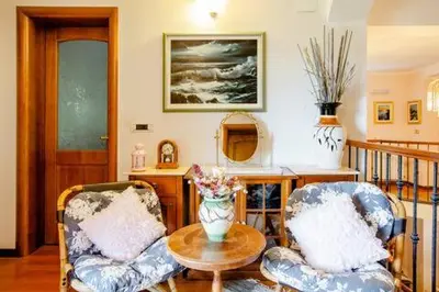 a living room with two chairs and a table at Rooms Leban in Šempas