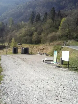 two benches on a dirt road next to a road at Apartments Maligoj in Tolmin