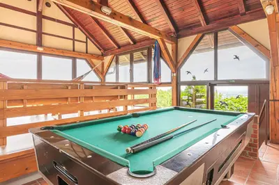 a pool table in a pavilion with cue balls on it at Podhamer Wellness Vineyard Cottages in Ljutomer