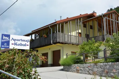 a building with a sign in front of it at Apartmaji Kobal in Zoll