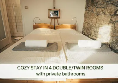 a bedroom with a bed with two pillows on it at Villa Lapis - stone house with amazing view in Črni Kal