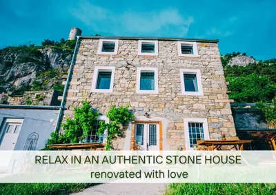 a stone house with a sign relax in an authentic stone house rewarded with love at Villa Lapis - stone house with amazing view in Črni Kal