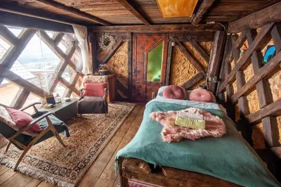 a bedroom in a tree house with a bed at Hay barn unique experience Visole in Slovenska Bistrica