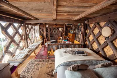 a bedroom with several beds in a room with wooden ceilings at Hay barn unique experience Visole in Slovenska Bistrica