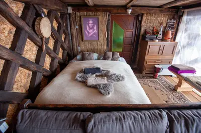a bedroom with a large bed in a cabin at Hay barn unique experience Visole in Slovenska Bistrica