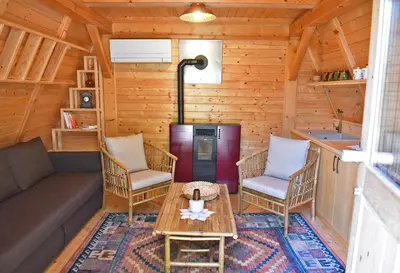 a living room with a couch and chairs and a table at Luxury Wellnes Glamping Cottage - Salvus in Lendava