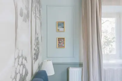 a living room with a window and a curtain at BRIDGE apartments in Ljubljana