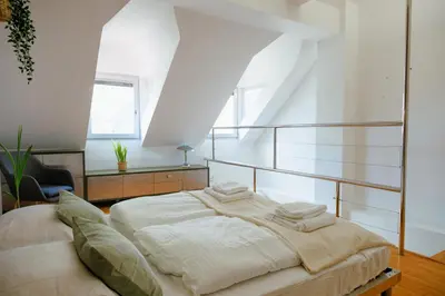 a bedroom with a large bed in a room at BRIDGE apartments in Ljubljana