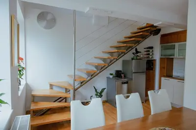 a kitchen with a staircase and a table and chairs at BRIDGE apartments in Ljubljana