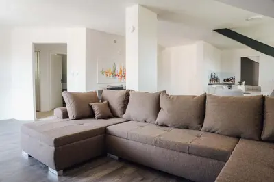 a large brown couch in a living room at Palace Garden in Ljubljana