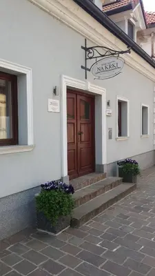 a building with a door and stairs in front at Apartment Na Krki in Kostanjevica na Krki