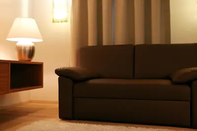 a living room with a couch and a lamp at Apartment Na Krki in Kostanjevica na Krki