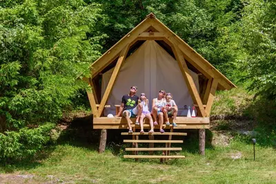 a group of three people sitting in front of a tent at Adrenaline Check Camping in Bovec