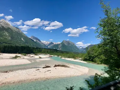 a view of a river with mountains in the background at Adrenaline Check Camping in Bovec