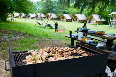 a grill with many different types of food on it at Adrenaline Check Camping in Bovec