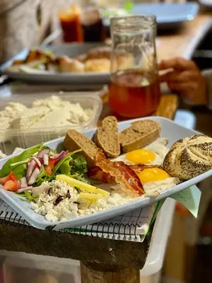 a plate of food with eggs and bread on a table at Adrenaline Check Camping in Bovec