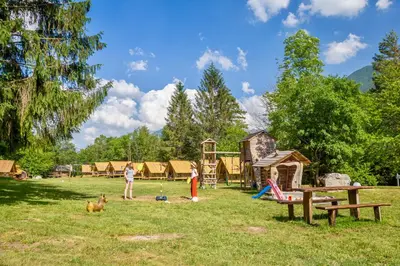 a group of people playing in a park with a playground at Adrenaline Check Camping in Bovec