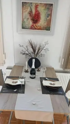 a dining room table with a vase on top of it at Apartment Joga in Rečica ob Savinji