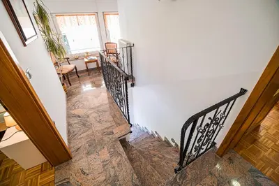a winding staircase in a home with white walls at Apartment Joga in Rečica ob Savinji