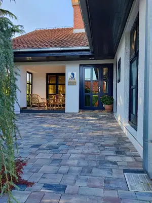 a patio in front of a house with a door at Salvus Apartma - Sun & Moon in Lendava