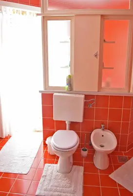 a bathroom with a toilet and a sink at Salvus Apartma - Sun & Moon in Lendava