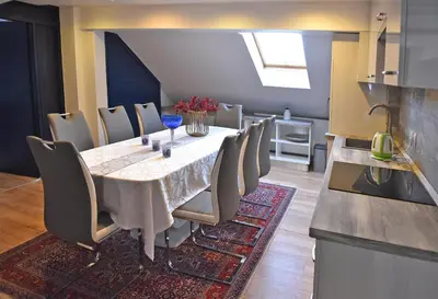 a dining room with a table and chairs at Salvus Apartma - Sun & Moon in Lendava