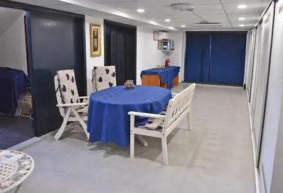 a table and chairs in a room with blue table cloth at Salvus Apartma - Sun & Moon in Lendava