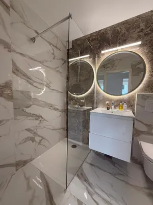 a bathroom with a sink and a mirror at Central Elite Vista-with parking in Ljubljana
