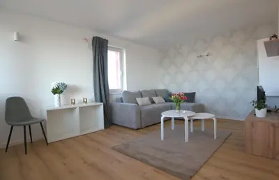a living room with a couch and a table at Central Elite Vista-with parking in Ljubljana