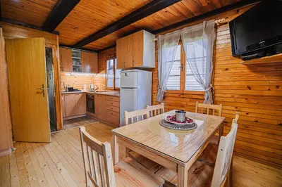 a dining room with a table and chairs in a cabin at Holiday Home Brina 69 in Čatež ob Savi