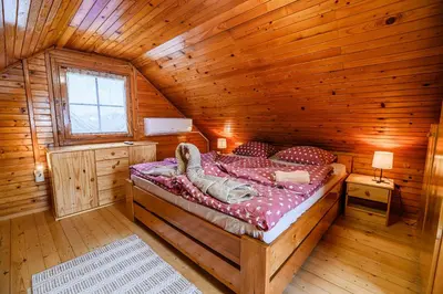 a bedroom with a bed in a wooden cabin at Holiday Home Brina 69 in Čatež ob Savi
