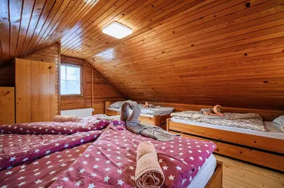 a room with three beds in a wooden cabin at Holiday Home Brina 69 in Čatež ob Savi