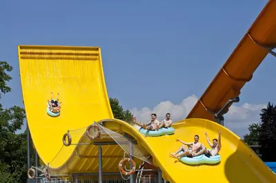 a group of people riding on a slide at a water park at Holiday Home Brina 69 in Čatež ob Savi