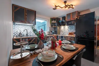 a kitchen with a wooden table with dishes on it at Deluxe House Maj in Brežice