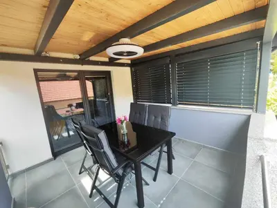 a dining room with a black table and chairs at Deluxe House Maj in Brežice