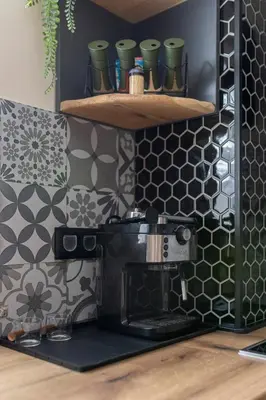 a kitchen with a espresso machine on a wall at Deluxe House Maj in Brežice