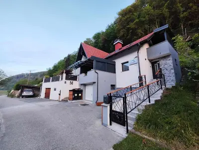 a building on a hill next to a street at Deluxe House Maj in Brežice