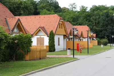 a row of houses with orange roofs on a street at Apartma Trobentica 15 in Moravske Toplice
