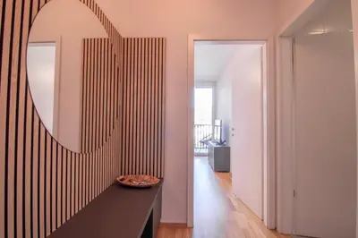 a mirror on the wall of a room with a hallway at Sunrise Bohinj Apartment in Bohinj