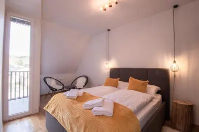 a bedroom with a large bed with two towels on it at Sunrise Bohinj Apartment in Bohinj