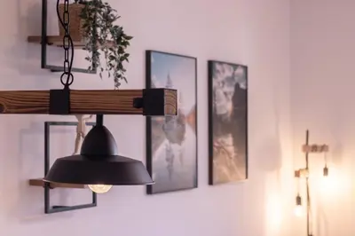 a black light hanging from a wall with pictures at Sunrise Bohinj Apartment in Bohinj