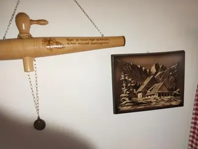 a wooden telescope hanging on a wall next to a picture at Wooden Treasure in Jesenice