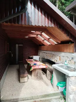 an outdoor patio with a bench and a table at Wooden Treasure in Jesenice