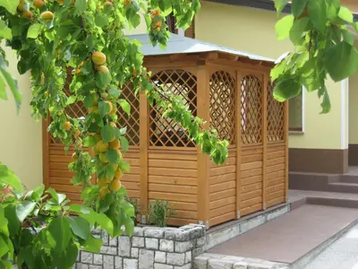 a wooden gazebo on the side of a house at Turistična kmetija Pri Rebkovih in Ajdovščina