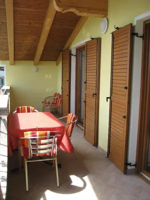 a dining room with a red table and chairs at Turistična kmetija Pri Rebkovih in Ajdovščina